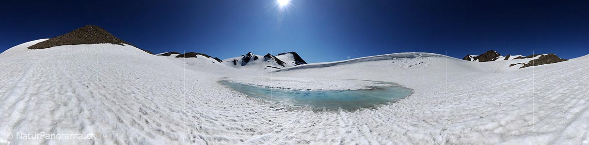 P005235: Panoramic picture of light blue water edge in snowy mountain lake