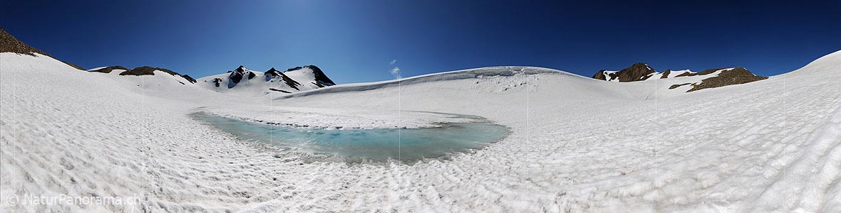 P005236: Panorama of light blue water edge in snowy mountain lake