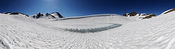 Large panoramic image Mountain lake with a magic melting water ring