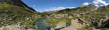 Panoramic photo of a watercourse in a primeval natural landscape