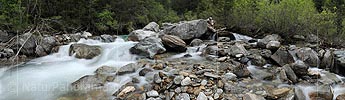 Panoramic photo Scree and boulders in mountain stream