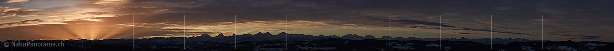 Panoramic photo Early morning with light beams and the Alps