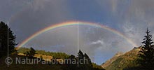 Panorama photo Rainbow over mountain valley